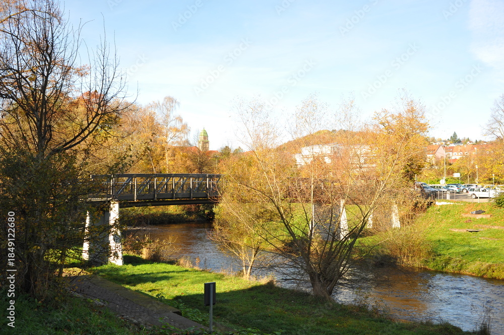 Obraz premium Colorful bridge view, Picturesque scene of vibrant river with treelined banks and historic stone bridge