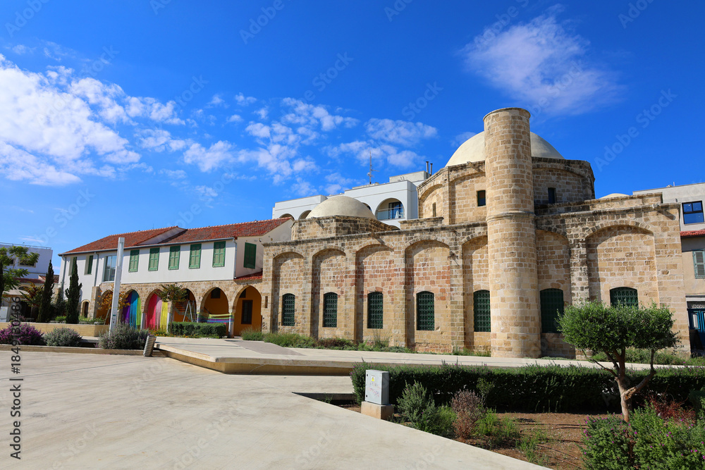 Fototapeta premium Zouhouri Mosque standing in the city of Larnaca, Cyprus. White domes of Zouhouri Mosque rising above the rooftops in Larnaca, Cyprus