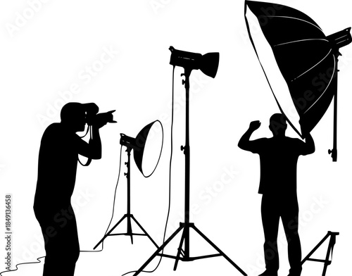Silhouette of two photographers with studio lighting equipment in a photography session setting on white
