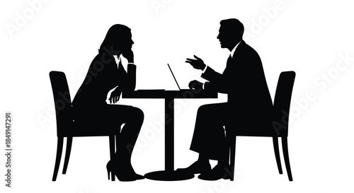 Silhouette of a business meeting between a man and a woman at a table