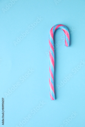 Merry Christmas card. Candy cane on a blue background.