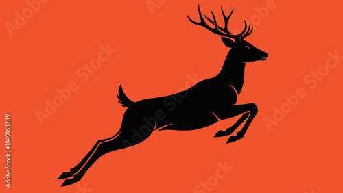 Silhouette of a majestic leaping stag with antlers on vibrant orange background
