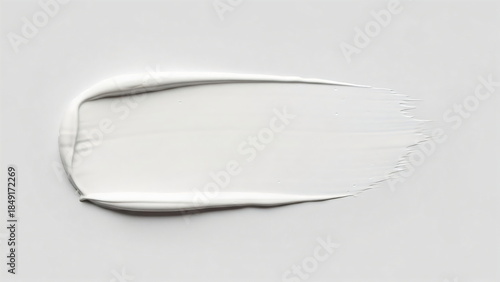 White paint smear on flat surface. Abstract brush stroke texture. Cosmetic cream or gel background for beauty product promotion. Cloud Dancer Color of the Year 2026