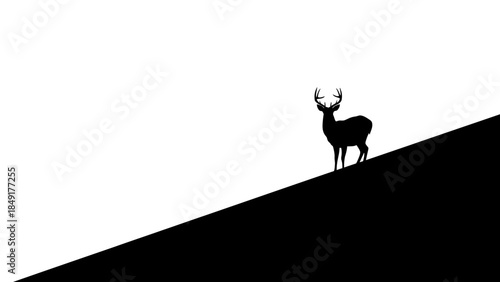 Silhouette of a majestic stag standing atop a sloped terrain with a stark black and white contrast