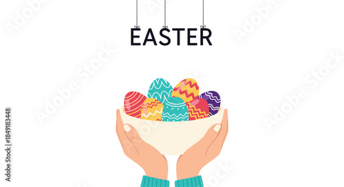 Hands gently hold a white bowl filled with colorfully decorated eggs under the hanging word Easter for the spring celebration.