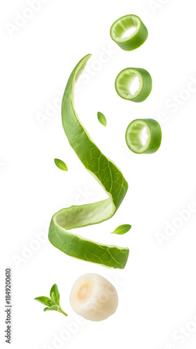 Fresh green onion slices and curled green onion leaves falling, isolated on white background, perfect for healthy recipes and cooking blogs