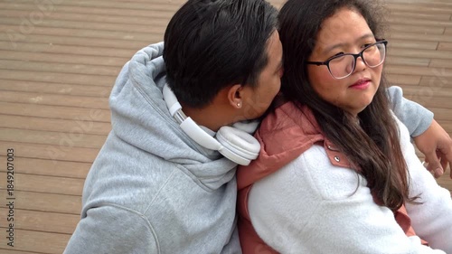Multiracial couple hugging outdoors with joyful and affectionate moment