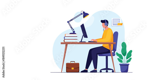 A man with headphones works or studies at his desk on a computer in a comfortable home office with a plant and briefcase.