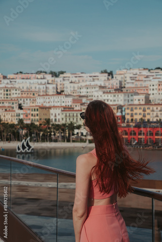 Young woman in a pink suit against the backdrop of Sunset Town in Vietnam