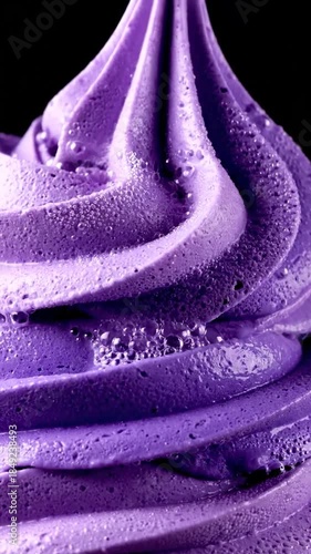 Close up of vibrant purple dessert swirls with textured surface on dark background