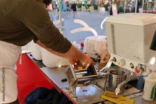 Male Hands Preparing Pumpkin for Soup at a Winter Market Stall
