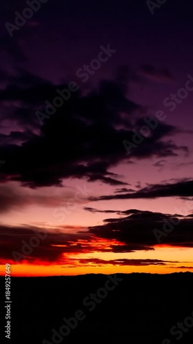 Dramatic sunset sky with clouds and bright sun over horizon natural light background