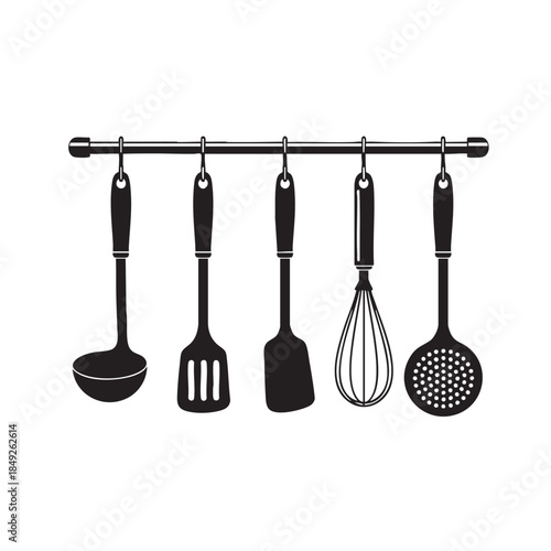 A professional set of domestic stainless steel kitchen utensils including a spatula, ladle, and spoon isolated on a white background as essential silver metal tools for household cooking