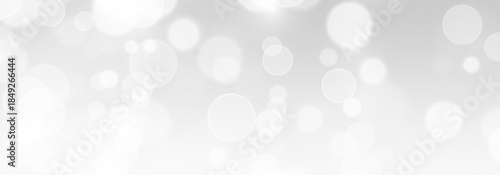 Festive sparkle bokeh light background with luminous dust particles and shimmer. Abstract white stardust atmosphere with bright confetti and luxury glow.