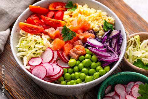 Balanced healthy bowl with vegetables and salmon