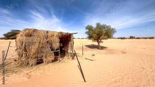 Mauritanian desert. A makeshift shelter made of straw in the middle of the desert