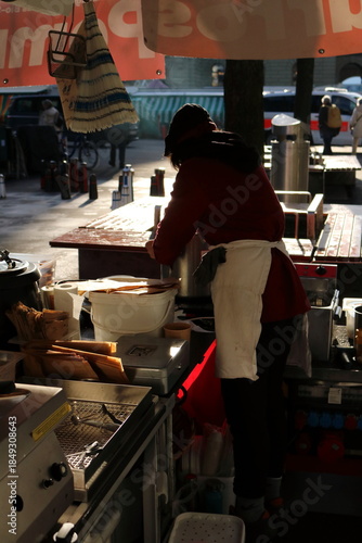 Young Woman Serving Soup at a Winter Market in Bern