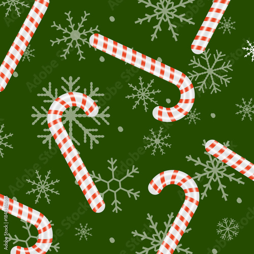 christmas candy canes and snowflakes background on green color