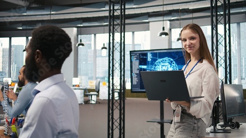 Принти на полотні Portrait of young smiling female programmer in office automating repetitive tasks using AI scripts