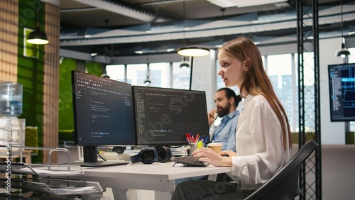Photos Happy female programmer dancing on office desk chair, pleased after managing to streamline workflows with AI