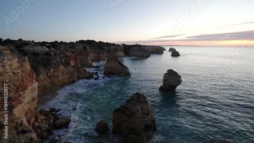 Marinha Beach, Cliffs, Sea Stacks and Atlantic Ocean at Sunrise. Algarve, Portugal