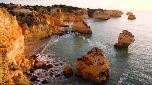 Marinha Beach, Sea Stacks, Cliffs and Atlantic Ocean in Sunny Morning. Lagoa, Algarve, Portugal. Golden Hour
