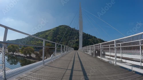 Riding across a Los Angeles river pedestrian, horse and bike bridge near Griffith Park and Glendale in Los Angeles California.  