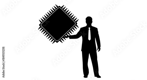 A silhouette of a man in a business suit presents a large microchip in a professional indoor setting.