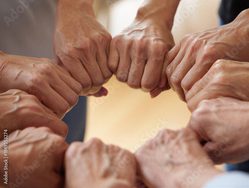 Diverse group of people joining hands in a circle for unity and support