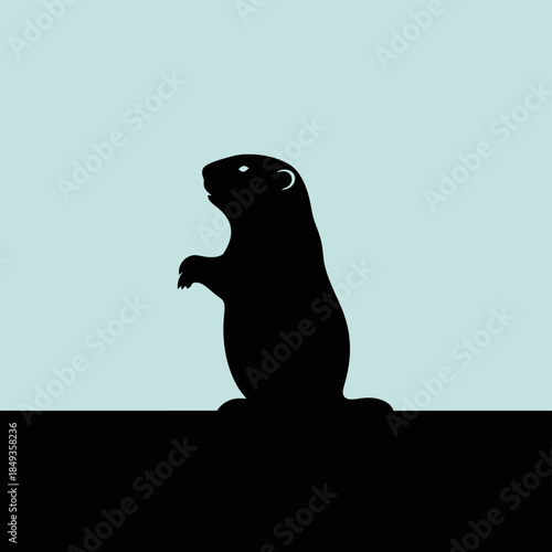 A silhouette of a groundhog standing upright on a rock against a light blue background.