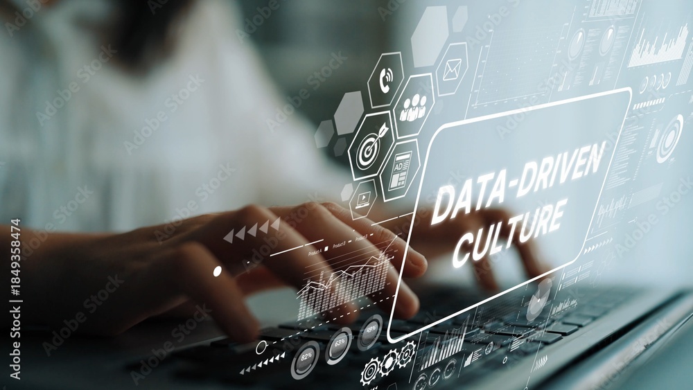 Fototapeta premium Hands Typing on Laptop with Data-Driven Culture Concept Graphic Overlay for Business and Technology Themes. Asymptotic smart data analytic.