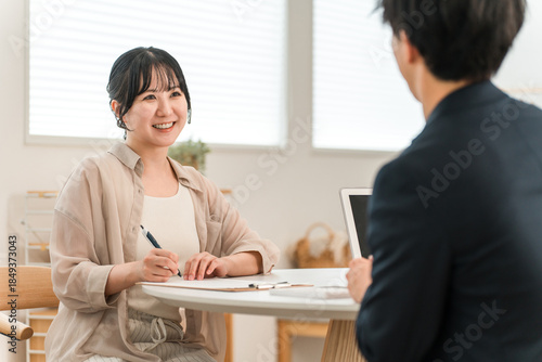 Wallpaper Mural A woman receiving advice, explanations, and introductions from a salesman during a door-to-door sales call Torontodigital.ca