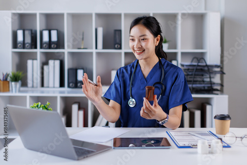 Cuadro en lienzo A woman Nurse, in a blue scrubs is smiling while holding a bottle of medicine