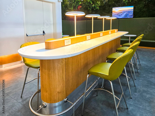chairs in a row with a bar counter.Modern interior design of waiting area, co working office in light colors, minimalism