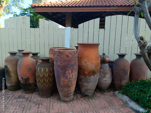 Traditional clay pottery jars displayed outdoors, showcasing rustic textures, handmade craftsmanship, and natural earth tones.