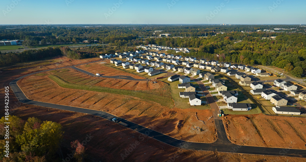 Fototapeta premium View from above of densely built residential houses under construction in south Carolina residential area. American dream homes as example of real estate development in US suburbs