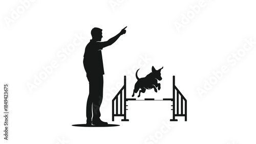 Man training dog to jump over hurdle