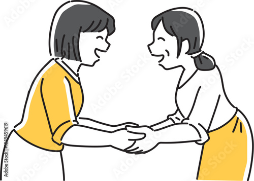 笑顔で手を握る女性2人