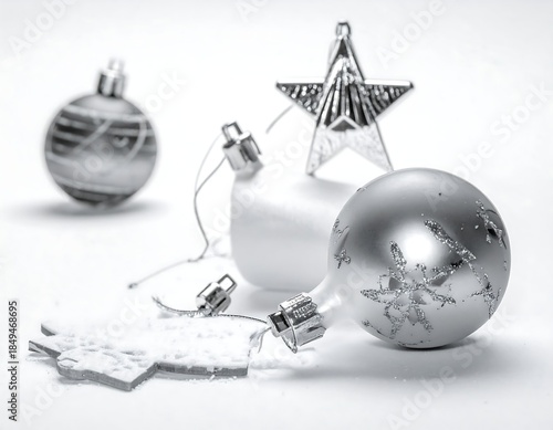 Black & white Christmas ornaments, star, on textured white surface
