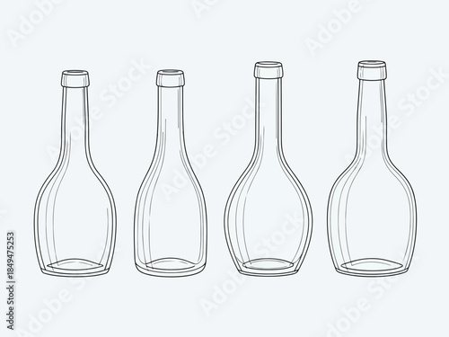 Four empty glass bottles with different shapes and designs