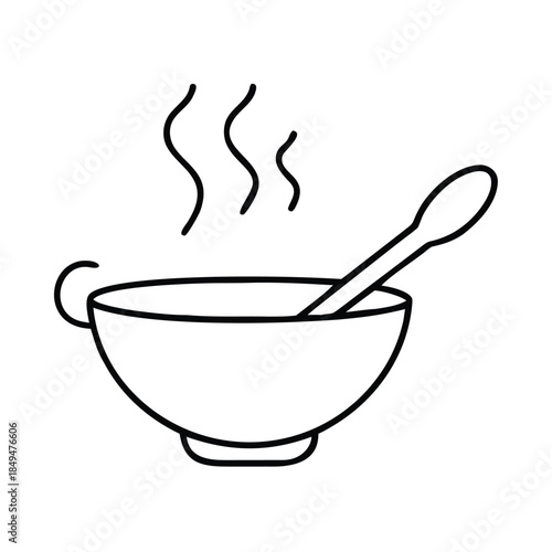 A steaming bowl of soup with a spoon sits on a table, inviting a warm meal.