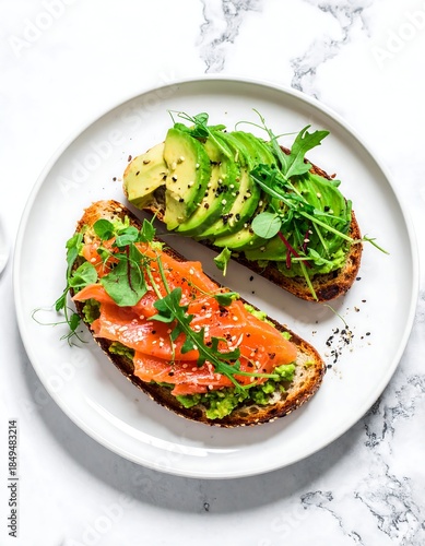 Delicious avocado and salmon toast slices on a marble surface