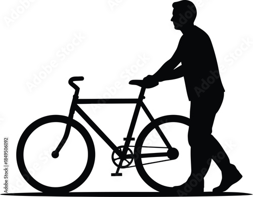 Silhouette of a man walking beside his bicycle