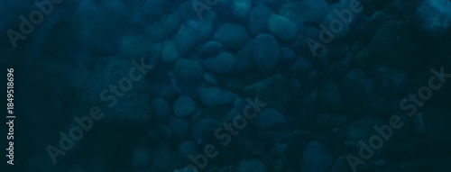 Photos stone seabed as dark blue background