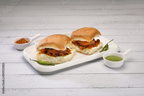 Vada Paav bombay snack on a white platter.