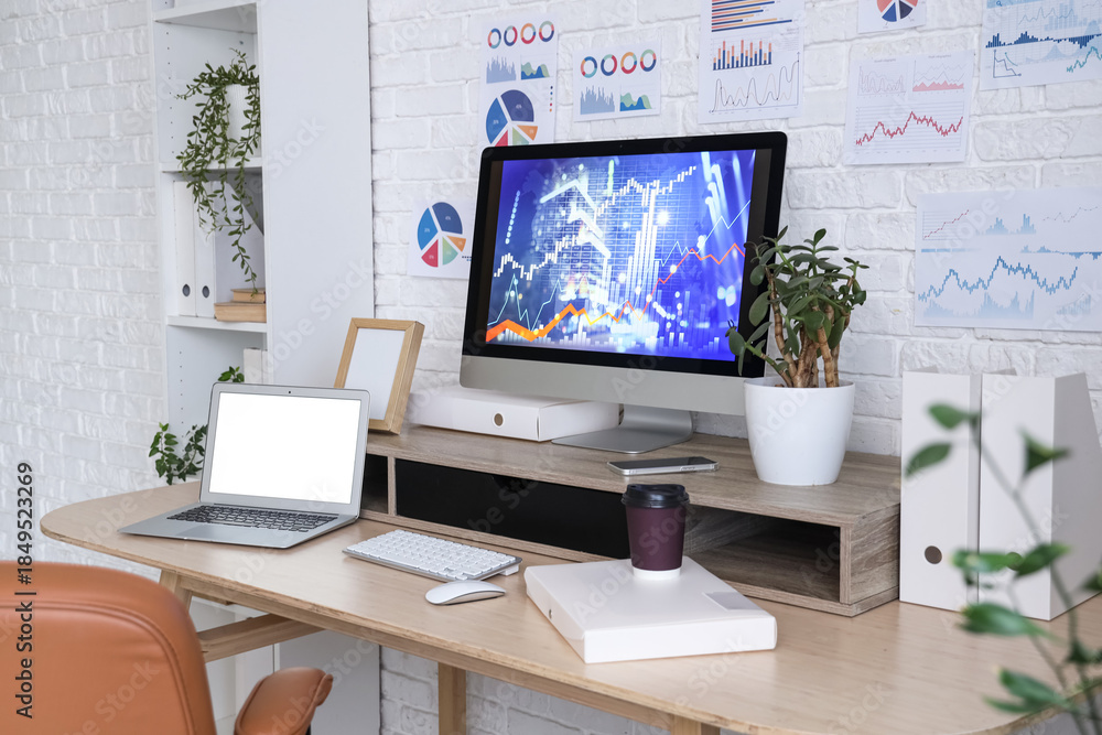 Fototapeta premium Data scientist's workplace with computer and diagrams in office