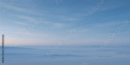 A beautiful view of the horizon where the blue sky and clouds meet the summer sea waves reflecting natural light across a calm ocean landscape