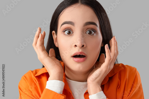 Scared young woman on light...