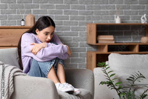 Scared young woman sitting ...