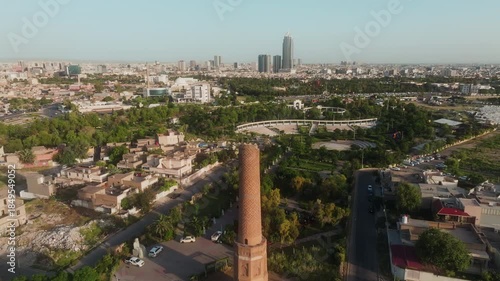 Wallpaper Mural Drone advancing over Mudhafaria Minaret toward Erbil skyline and park sports field. Torontodigital.ca